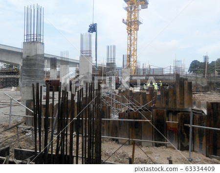 Temporary sheet pile cofferdam retaining wall at the construction site. It is installed to allow soil excavation and foundation work start. Temporary sheet pile cofferdam retaining wall at the construction site. It is installed to allow soil excavation and foundation work start. 63334409