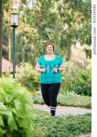Jogging overweight woman Jogging overweight woman 63334499