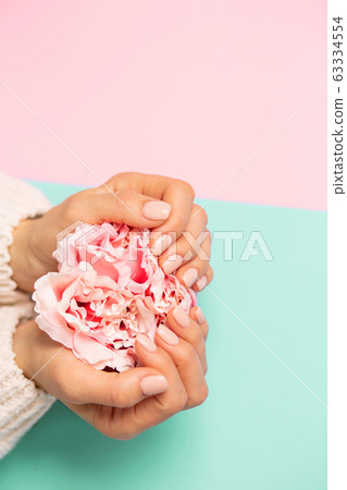 Beautiful woman's hands on background Beautiful woman's hands on background 63334554