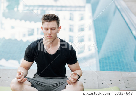 Meditating young man 63334648