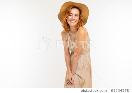 Cheerful woman with fair red hair in beautiful dress smiles, picture isolated on white background 63334978