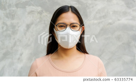 Asian woman wears glasses and a mask Asian woman wears glasses and a mask 63335774