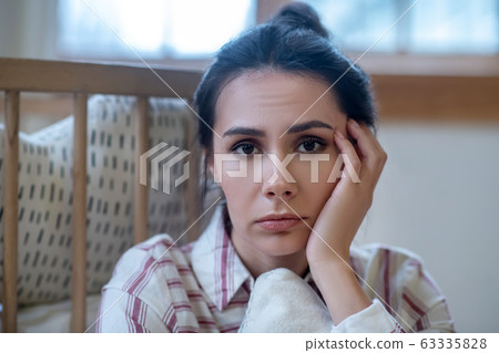 Sad young woman propping up her head Sad young woman propping up her head 63335828