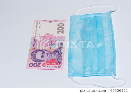 Protective medical mask and Ukrainian hryvnia. Protective medical mask and Ukrainian hryvnia. 63336231