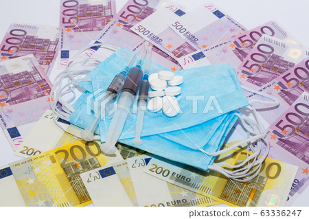 Tablets, protective mask, syringe and euro bills. Tablets, protective mask, syringe and euro bills. 63336247