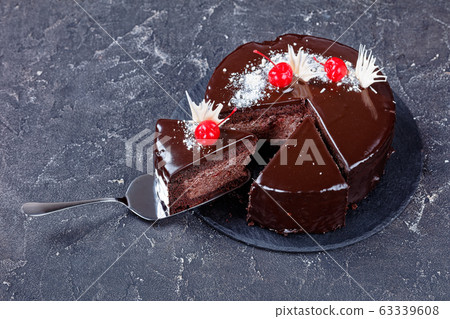 Slice of chocolate cake placed on a cake spatula 63339608