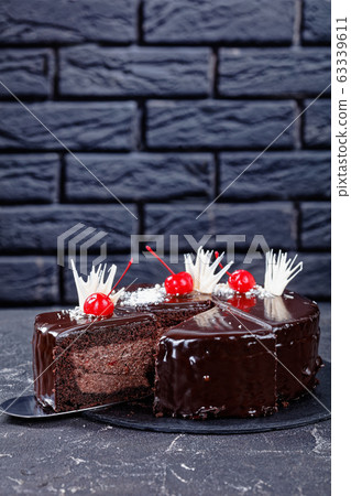 Devil's chocolate cake in front of a black wall Devil's chocolate cake in front of a black wall 63339611