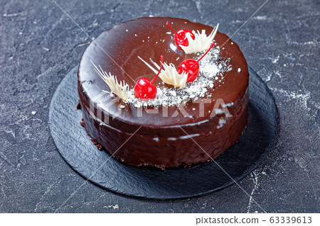Devil's chocolate cake with cherries on top Devil's chocolate cake with cherries on top 63339613