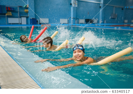 Children swimming group lies on back in the pool Children swimming group lies on back in the pool 63340517