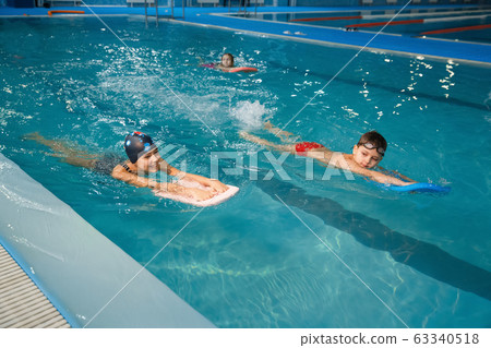 Children swimming group, workout in the pool Children swimming group, workout in the pool 63340518