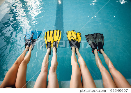 Female group at the poolside, feet in flippers Female group at the poolside, feet in flippers 63340607