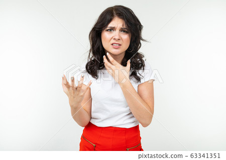 disgruntled girl in a white T-shirt is fed up on a white studio background 63341351