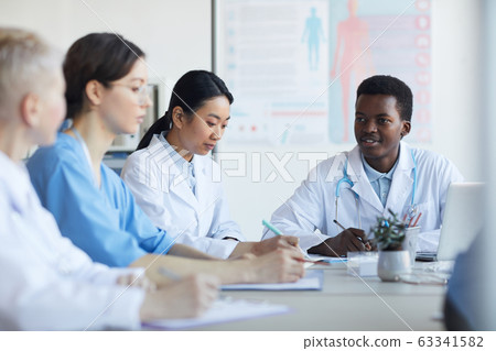 Young African Doctor Speaking in Meeting 63341582