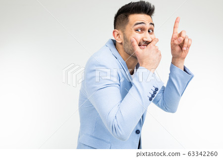 funny gentleman covers his mouth with his hand on a white studio background 63342260