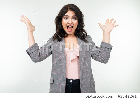 joyful winner in a gray checkered jacket on a white studio background 63342261