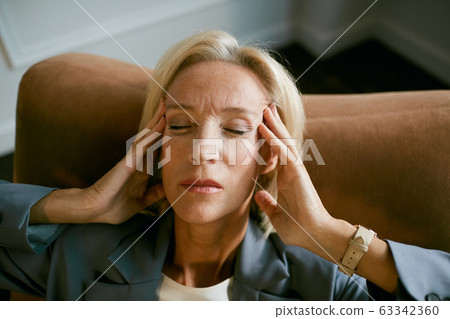 Mature Businesswoman Suffering from Headache 63342360