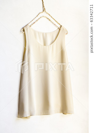 White beige tank top on a hanger 63342711