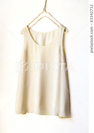 White beige tank top on a hanger 63342712