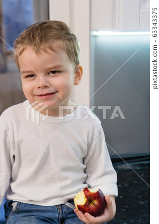 Сute emotional boy in the kitchen 63343375