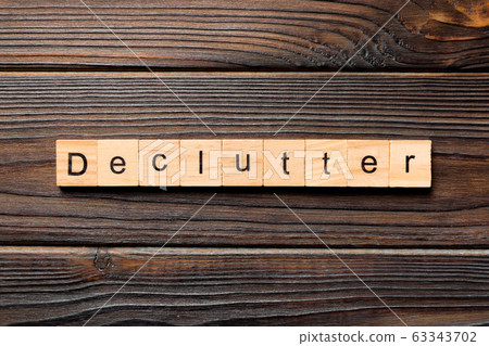 Declutter word written on wood block. Declutter Declutter word written on wood block. Declutter 63343702
