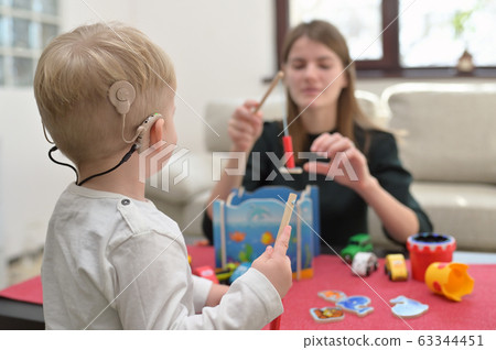 A Boy With A Hearing Aids And Cochlear Implants 63344451