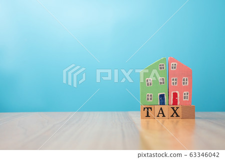 Wooden house on tax. The concept of finance and investment in property residential and tax payment. 63346042