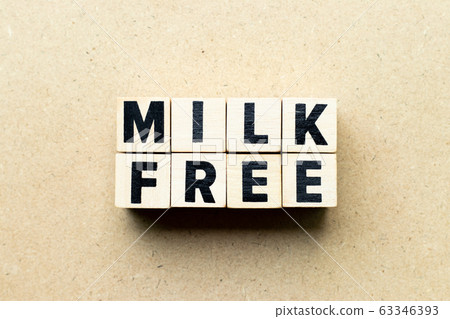 Letter block in word milk free on wood background Letter block in word milk free on wood background 63346393