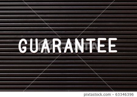 Black color felt letter board with white alphabet in word guarantee background Black color felt letter board with white alphabet in word guarantee background 63346396