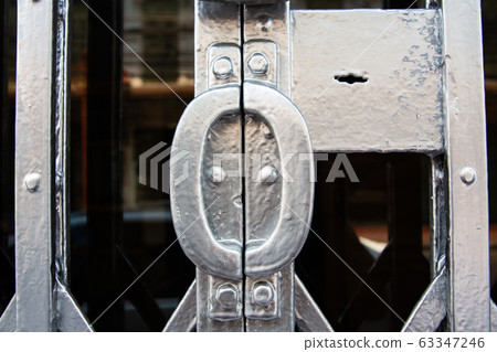 Closed silver steel door stretch with locked key, Close up & Macro shot, Selective focus Closed silver steel door stretch with locked key, Close up & Macro shot, Selective focus 63347246