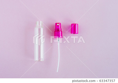 Transparent glass perfume and cosmetic spray bottle on pink background 63347357