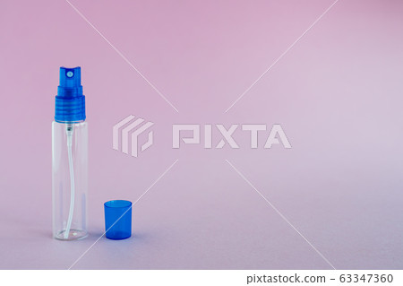 Transparent glass perfume and cosmetic spray bottle on pink background Transparent glass perfume and cosmetic spray bottle on pink background 63347360