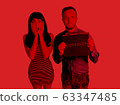 Coronavirus, red warning sign with the text Coronavirus in boy hands. Nearby, a girl in a panic holds on to her face. Epidemic, Chinese coronavirus 2020. 63347485