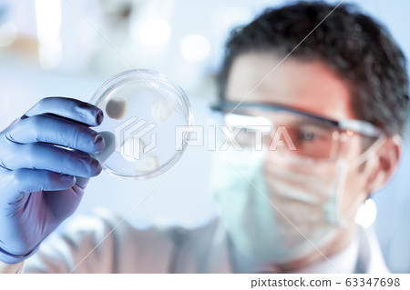 Scientist working in corona virus vaccine development laboratory research facility. Scientist working in corona virus vaccine development laboratory research facility. 63347698