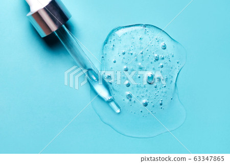 Pipette with dose of fluid hyaluronic acid on blue background Pipette with dose of fluid hyaluronic acid on blue background 63347865