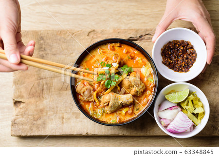 Northern Thai food (Khao Soi), spicy curry noodles soup with coconut milk and chicken 63348845