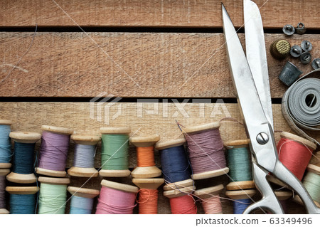 Spools of multicolored threads, tailoring scissors 63349496