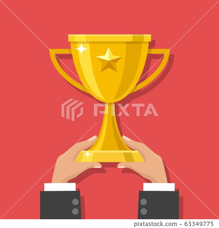 Hands holding gold trophy cup 63349775
