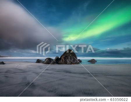 Aurora Borealis. Skagsanden beach on Lofoten Islands, Norway.. Stars and northern light. 63350022
