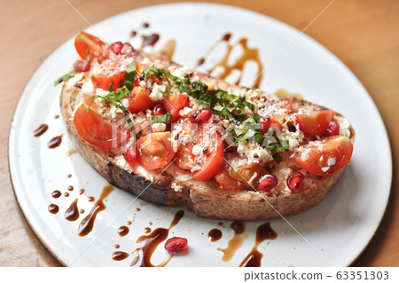 Bruschetta italian appetizer food, Crusty toasting bread with fresh tomato Bruschetta italian appetizer food, Crusty toasting bread with fresh tomato 63351303