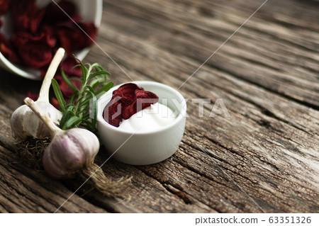 Beetroot Chips. Useful handmade vegetable snack. In a dish are pieces of root vegetables. Garlic, rosemary and sauce in a dish bowl. Soft focus 63351326