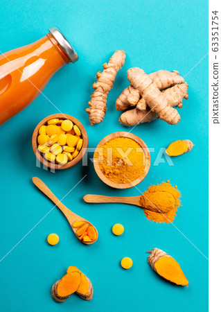 Turmeric in different conditions: fresh, dry root, pills, powder and cut plant. Turmeric in different conditions: fresh, dry root, pills, powder and cut plant. 63351754