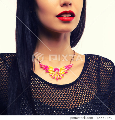 The beautiful woman in expensive necklace isolated The beautiful woman in expensive necklace isolated 63352469