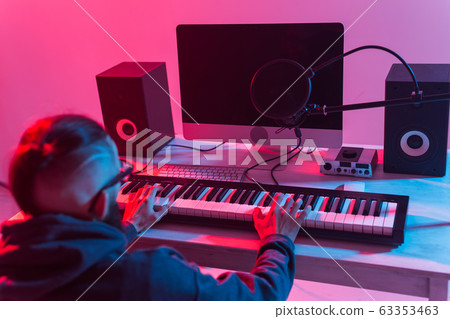 Musician and making music concept - Male sound producer working in recording studio. Musician and making music concept - Male sound producer working in recording studio. 63353463