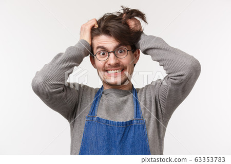 Portrait of distressed and tensed young male barista going insane with lots orders, pulling hair out of head crazy look camera, cant bear stress, feeling disturbed and annoyed, white background Portrait of distressed and tensed young male barista going insane with lots orders, pulling hair out of head crazy look camera, cant bear stress, feeling disturbed and annoyed, white background 63353783
