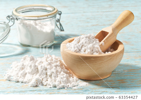 Wooden bowl with corn starch close-up on a wooden Wooden bowl with corn starch close-up on a wooden 63354427