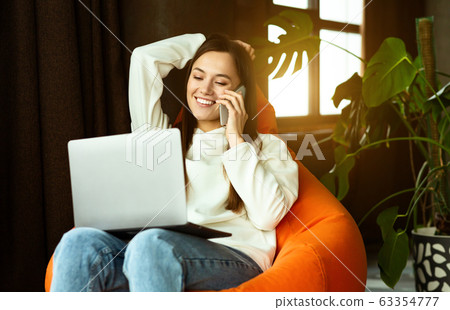 Freelance work from anywhere. Girl communicates on smartphone 63354777