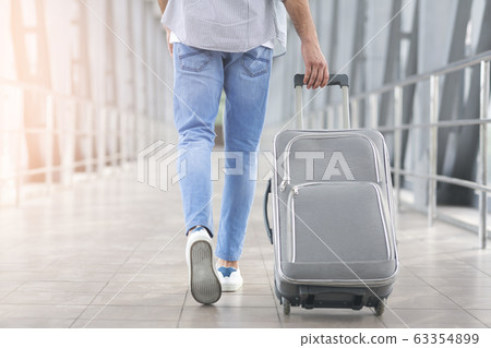 Weekend Trip. Unrecognizable Man Walking With Luggage In Aiport, Rear View 63354899
