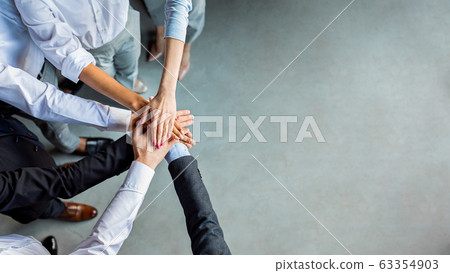 Unrecognizable Business People Holding Hands Standing In Modern Office, Above-View 63354903