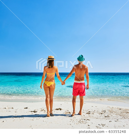 Couple walking on a tropical beach Couple walking on a tropical beach 63355248