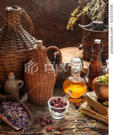 Rose hips and dried herbs with vintage bottles Rose hips and dried herbs with vintage bottles 63355506